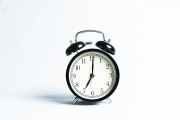 Black alarm clock isolated on white