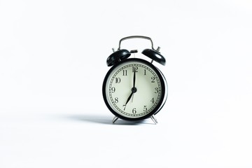 Black alarm clock isolated on white