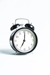 Black alarm clock isolated on white