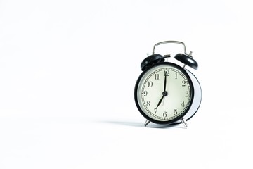 Black alarm clock isolated on white