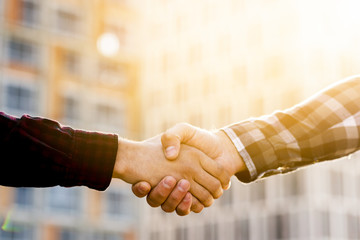 Close-up of engineer and architect  shaking hands