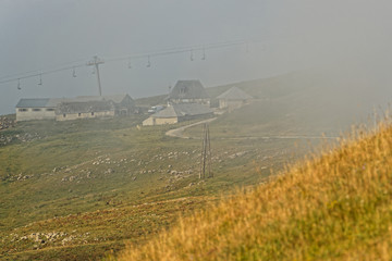 Farm and meadow through the clouds at sunrise