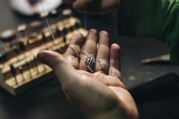 Close up of jeweler hand with heart shape pendant