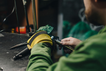 Jeweler polishing a silver ring