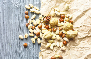 mixed nuts on a wooden table, top view