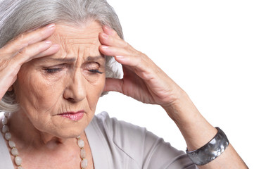 Portrait of sad senior woman on white background