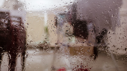 Rain Drops On Surface of wet Window Glass pane In Rainy Season. Abstract background. Natural...