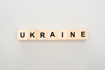 top view of wooden blocks with Ukraine lettering on white background