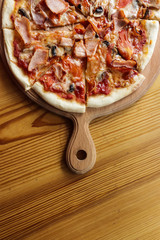 Tasty hot pizza on wooden table