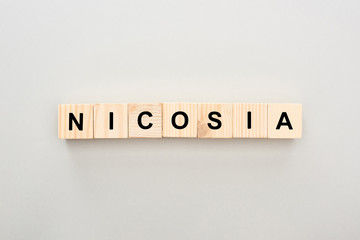 top view of wooden blocks with Nicosia lettering on white background