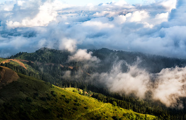 Panorama of south slope of Rosa Khutor resort in Krasnaya Polyana (Sochi, Russia) at cloudscape and mountains background