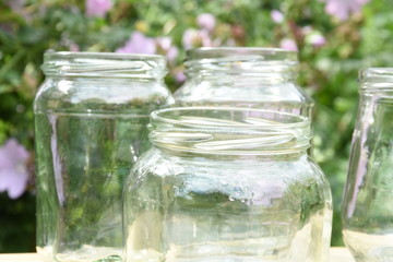 empty glass jam jars in the garden