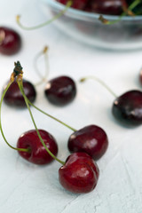 cherries in a bowl isolated on white. fresh red cherries on a white table.