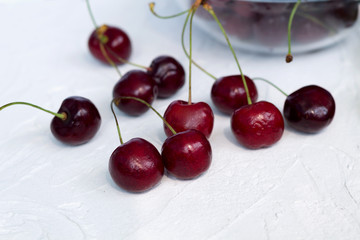 cherries in a bowl isolated on white. fresh red cherries on a white table.