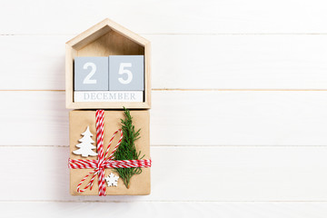 Christmas calendar 1 december. Christmas gift, fir branches on wooden white background. Copy space, top view