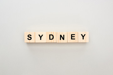 top view of wooden blocks with Sydney lettering on grey background