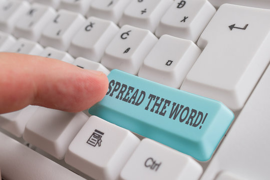 Conceptual hand writing showing Spread The Word. Concept meaning share the information or news using social media White pc keyboard with note paper above the white background