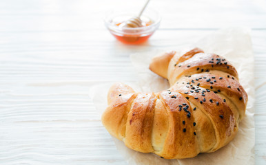 croissant on the white textured wooden background top view, cozy and delicious breakfast. Rustic background with copy space