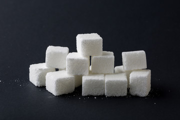 Sugar cube ingredient closeup on black background