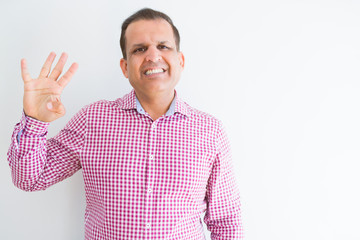 Middle age man wearing business shirt over white wall showing and pointing up with fingers number four while smiling confident and happy.