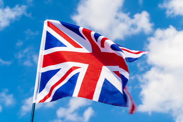 United Kingdom Flag waving on wind in blue sky