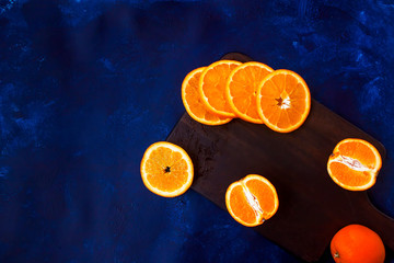 Fresh sliced oranges on wooden board
