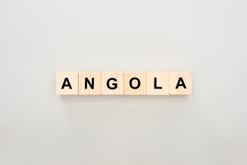 top view of wooden blocks with Angola lettering on white background