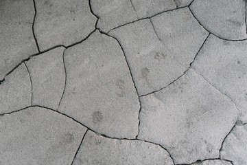 Obraz premium Grey cracked earth ground from drought disaster cause from weather change. The global warming and greenhouse effect cause of agricultural production is reduced.