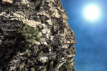 rock and gloomy sky sun