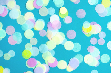 Obraz na płótnie Canvas Turquoise background with many round multicolored confetti.