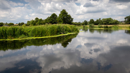 the river stour at fiddleford mill with clouds and reflections in river
