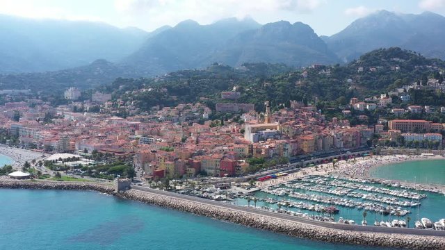 Harbor of Menton colorful houses basilica Alps mountains mediterranean seaside resort Franco-Italian border sunny day 