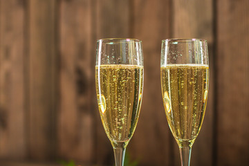 champagne in transparent glasses and a bottle (New Year's atmosphere, Christmas) of happy holidays! top food background. copy space