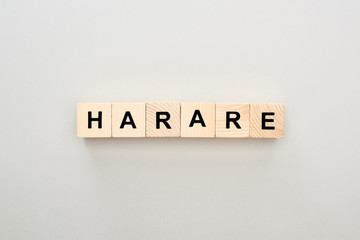 Obraz premium top view of wooden blocks with Harare lettering on grey background