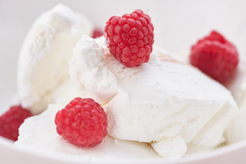 Ice cream with ripe fresh raspberries. Close-up