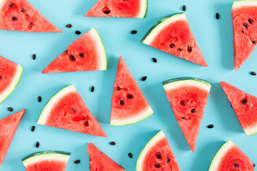 Sliced watermelon on light blue background. Watermelon slice. Summer concept. Flat lay, top view, copy space