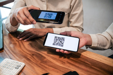 Qr code payment. Woman scanning QR code online shopping cashless technology concept.