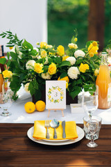 Elegant wedding table arrangement, floral decoration, restaurant. Wedding table setup. Wedding in the forest. Seat numbers. Lemon theme - 282847431