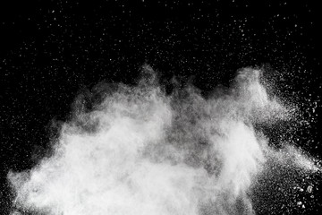 White powder explosion on black background. Colored cloud. Colorful dust explode. Paint Holi.
