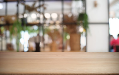 Empty dark wooden table in front of abstract blurred bokeh background of restaurant . can be used for display or montage your products.Mock up for space.