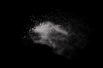White powder explosion on black background. Colored cloud. Colorful dust explode. Paint Holi.