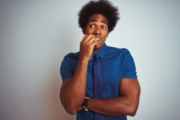 American business man with afro hair wearing blue shirt and tie over isolated white background...