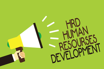 Conceptual hand writing showing Hrd Human Resources Development. Business photo showcasing helping employees develop personal skills Man holding megaphone green background message speaking loud