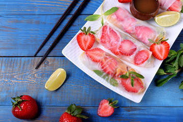 Spring rolls with strawberry, fruits and sauce. Vietnamese cuisine snack
