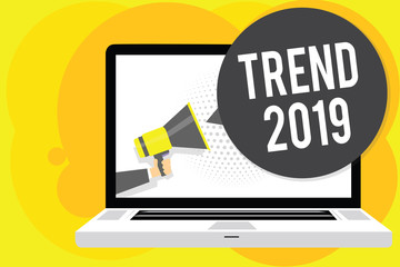 Conceptual hand writing showing Trend 2019. Business photo showcasing things that is famous for short period of time in current year Man holding Megaphone computer screen talking speech bubble