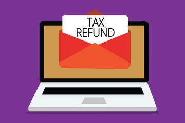 Handwriting text writing Tax Refund. Concept meaning applied when money liability is less than the paid ones Computer receiving email important message envelope with paper virtual