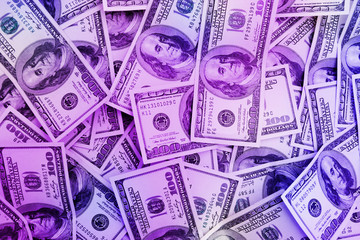 money background from 100 dollar bills in neon light