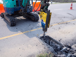 Road works  building site excavator and worker