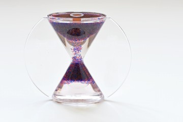 Front view of an hourglass (clepsydra, sand glass) on white background.