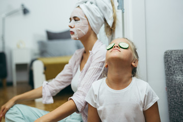 woman and her daughter cosmetic skin treatment at home